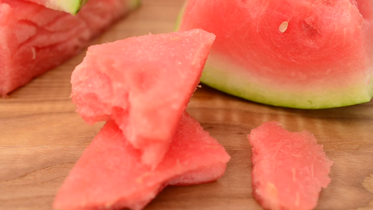 Shooting of a watermelon on a kitchen board. Shooting in the movement