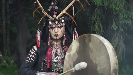 shaman walks and plays the drum