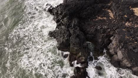 forward tracking aerial view of rugged volcanic coastline on snæfellsnes peninsula, iceland with crashing waves
