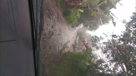 rainwater drips down the windshield of the car in the rainy season with full shake because of the bad roads