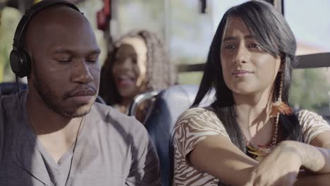 diverse commuters riding a bus