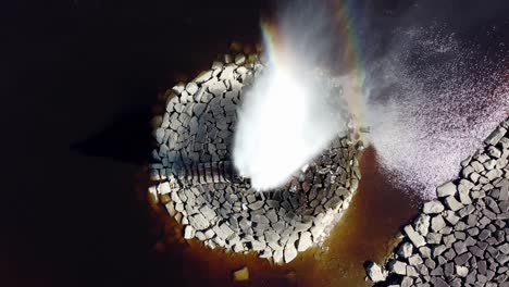 drone shot, fountain with a rainbow, top down