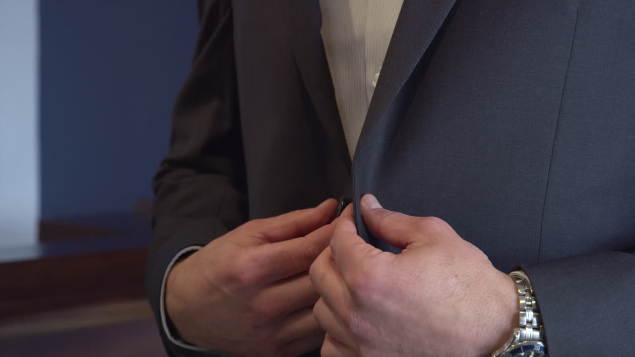 Faceless caucasian businessman dressing with an elegant blue jacket