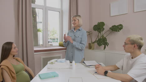 teacher showing products for the baby in class