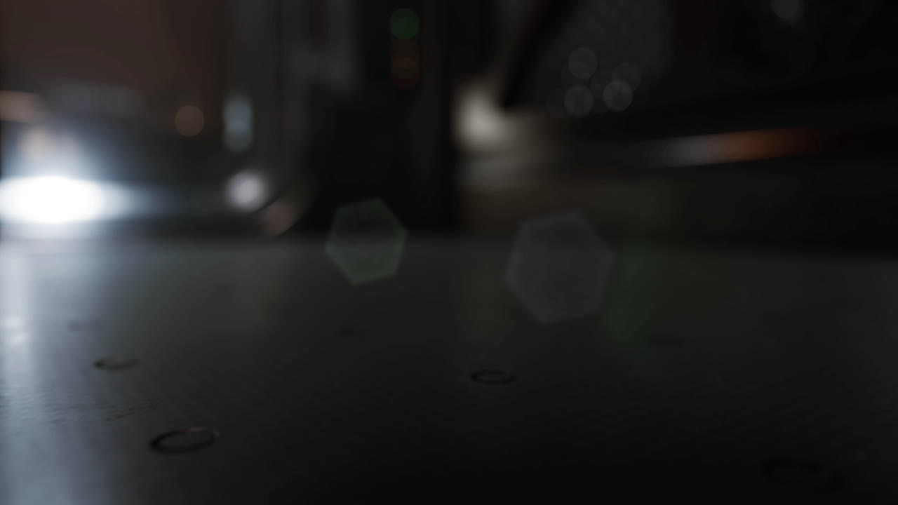 Mysterious illuminated surface with reflections in dim light at night