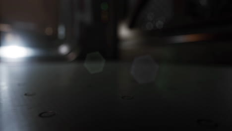 mysterious illuminated surface with reflections in dim light at night