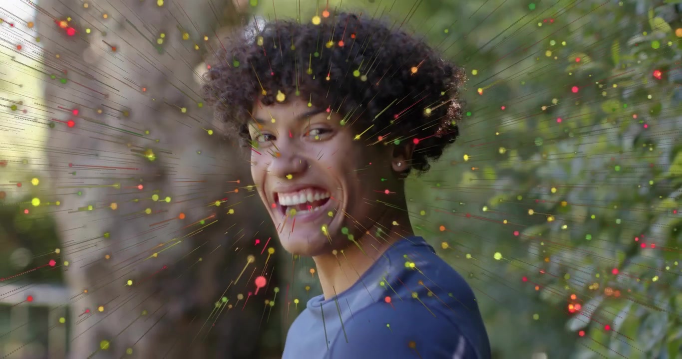 Homme exhalant une explosion de particules colorées et tournant la tête lors d'une démonstration technologique pour les spécialistes du marketing.