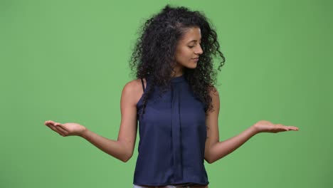 young beautiful hispanic businesswoman choosing between left and right