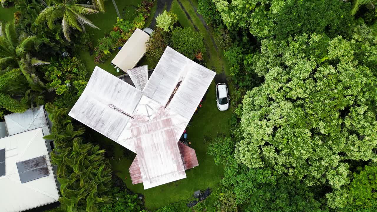 Aerial: Passing over small hidden house in Oahu, Hawaii