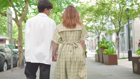 happy man woman love couple together holding hands and shopping in street summer