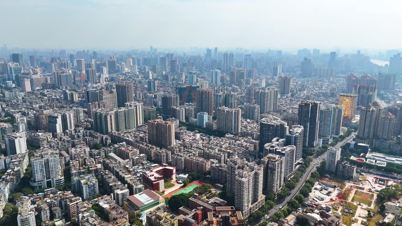 Drone shot of Shenzhen's cityscape, a sprawling urban environment filled with high-rise buildings. China