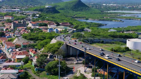 orbit around queen juliana bridge, willemstad curacao as cars drive up commuting across road