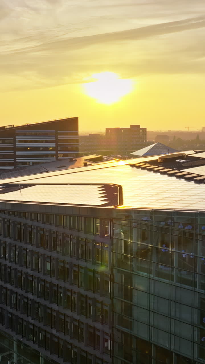 Aerial drone view of the Islands Brygge harbourfront area in central Copenhagen, Denmark at sunset. Vertical
