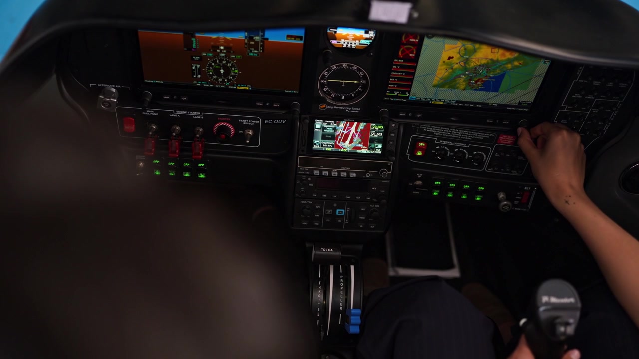 Pilots Operating Modern Airplane Cockpit Controls and Navigation