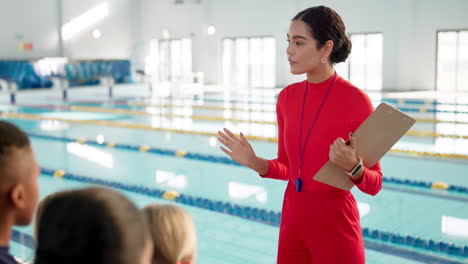 swim coach instructing children at a swimming pool