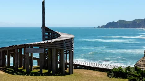 scenic pan over time dock and beach cliff in tepuhueico park coastal zone, cucao chile