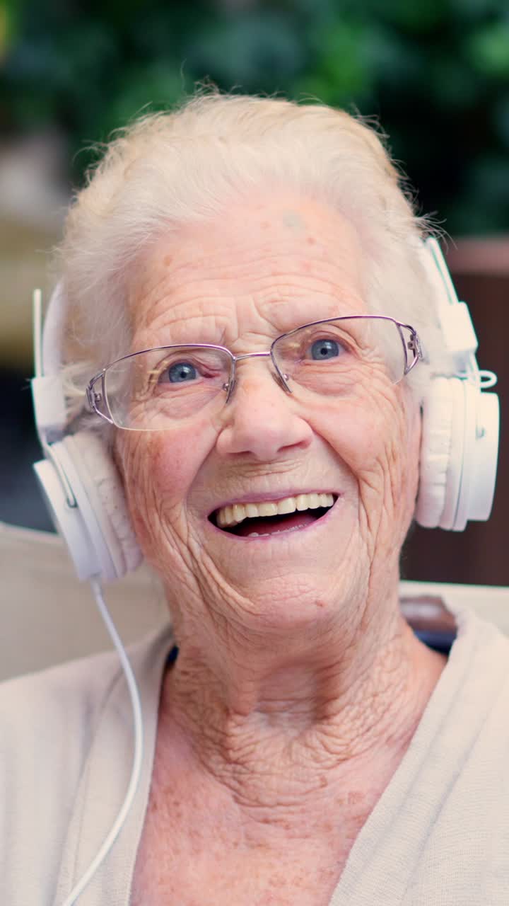 Elderly woman listening to music with headphones