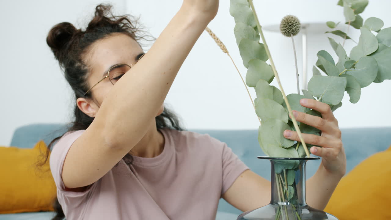 Woman Arranging a Flower Bouquet in Vase