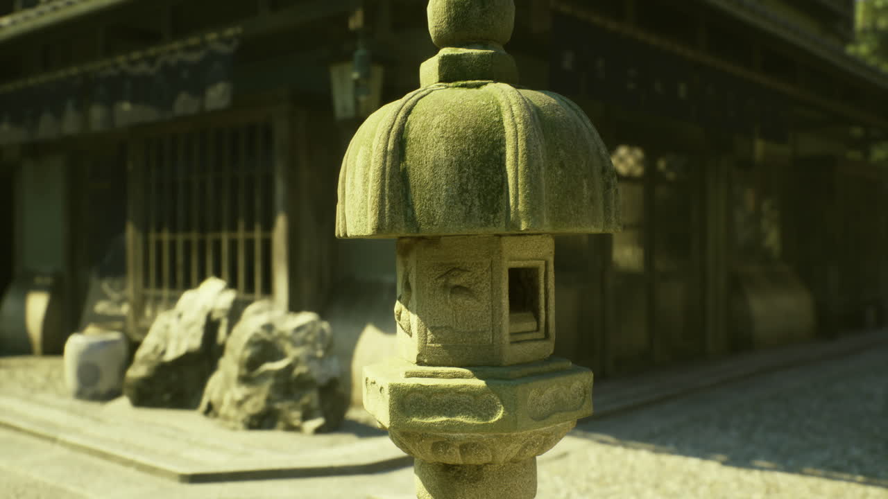 Ancient stone lantern in a traditional japanese garden during sunny daylight