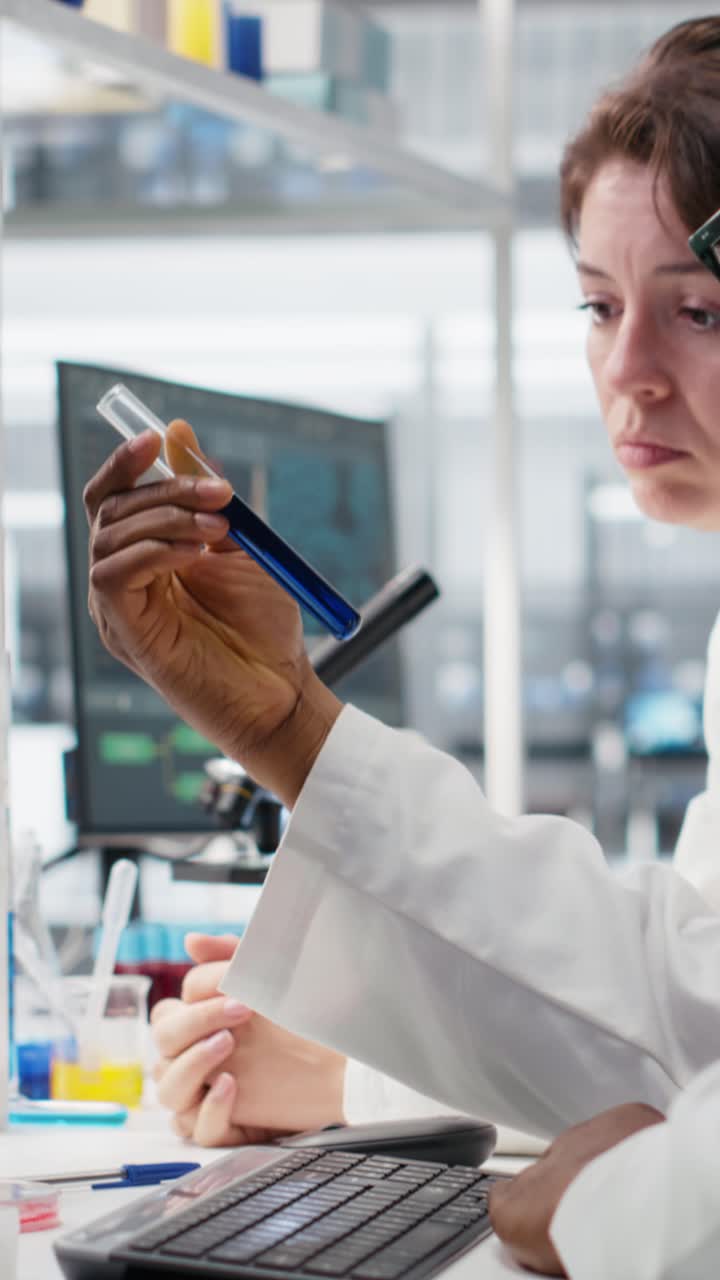 Vertical video Team of lab chemical engineers inspecting clarity of chemical solution