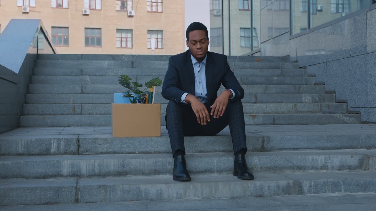 Unemployed Businessman Sitting on Stairs