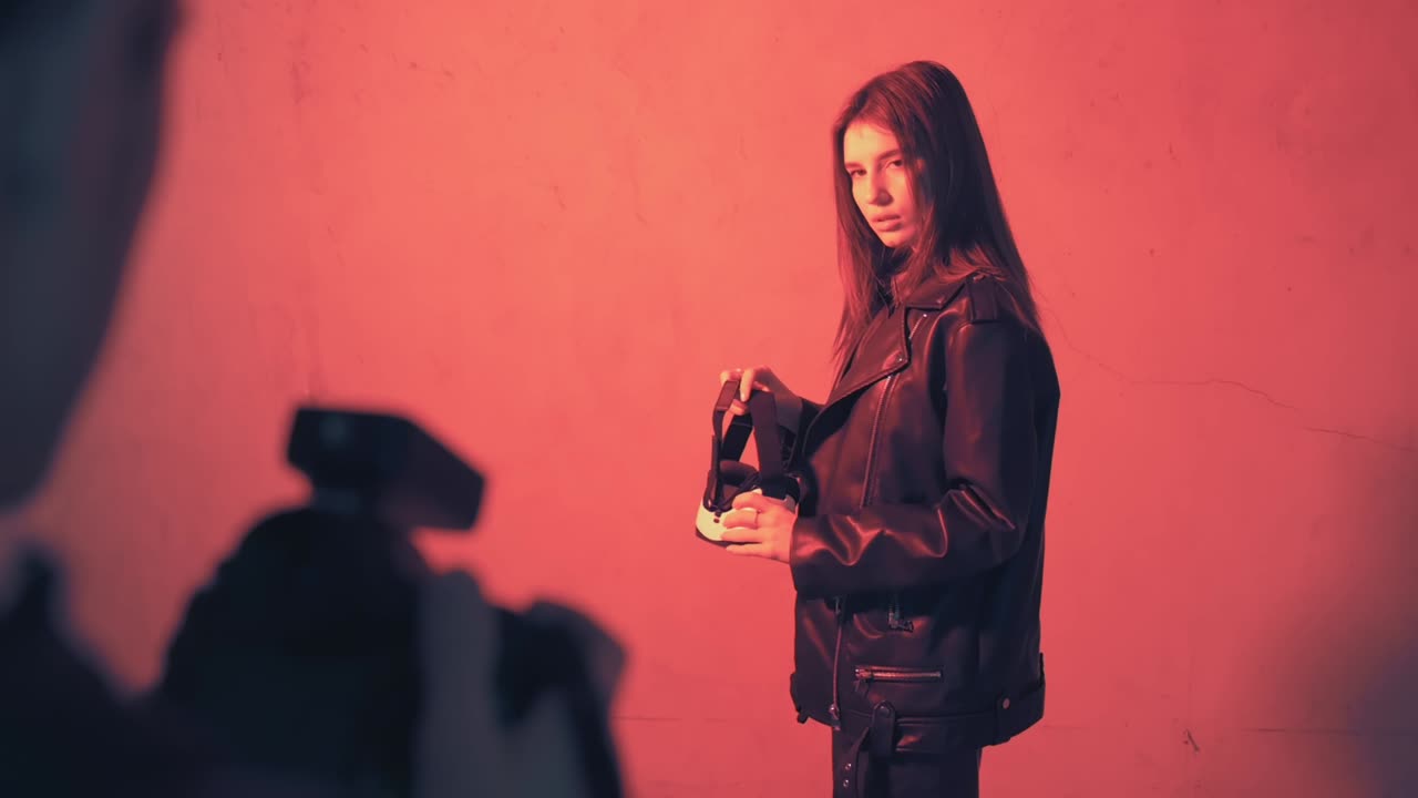 Photographer taking photo of a model with a virtual reality head set