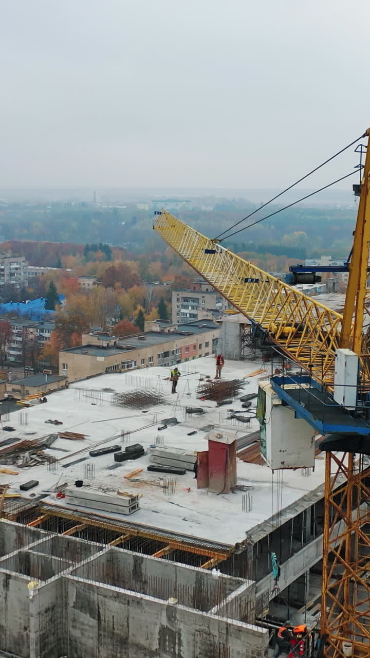 Construction of a residential apartment complex. Aerial view. Vertical video
