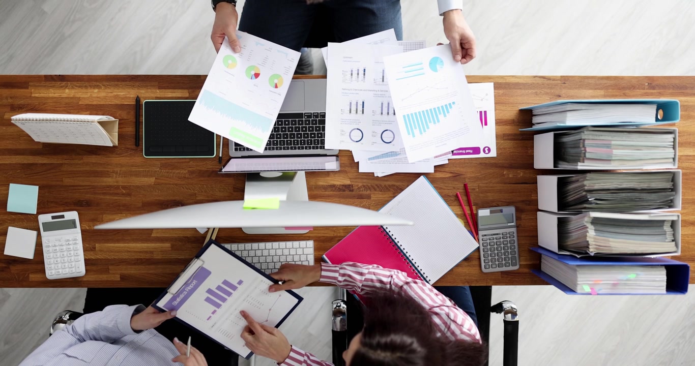 Colleagues compare business charts creating data routine scene