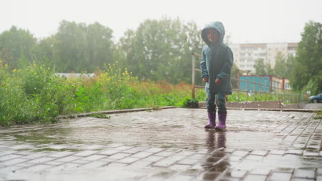 child leaps in puddle in yard area active kid embodies carefree spirit of outdoor play against