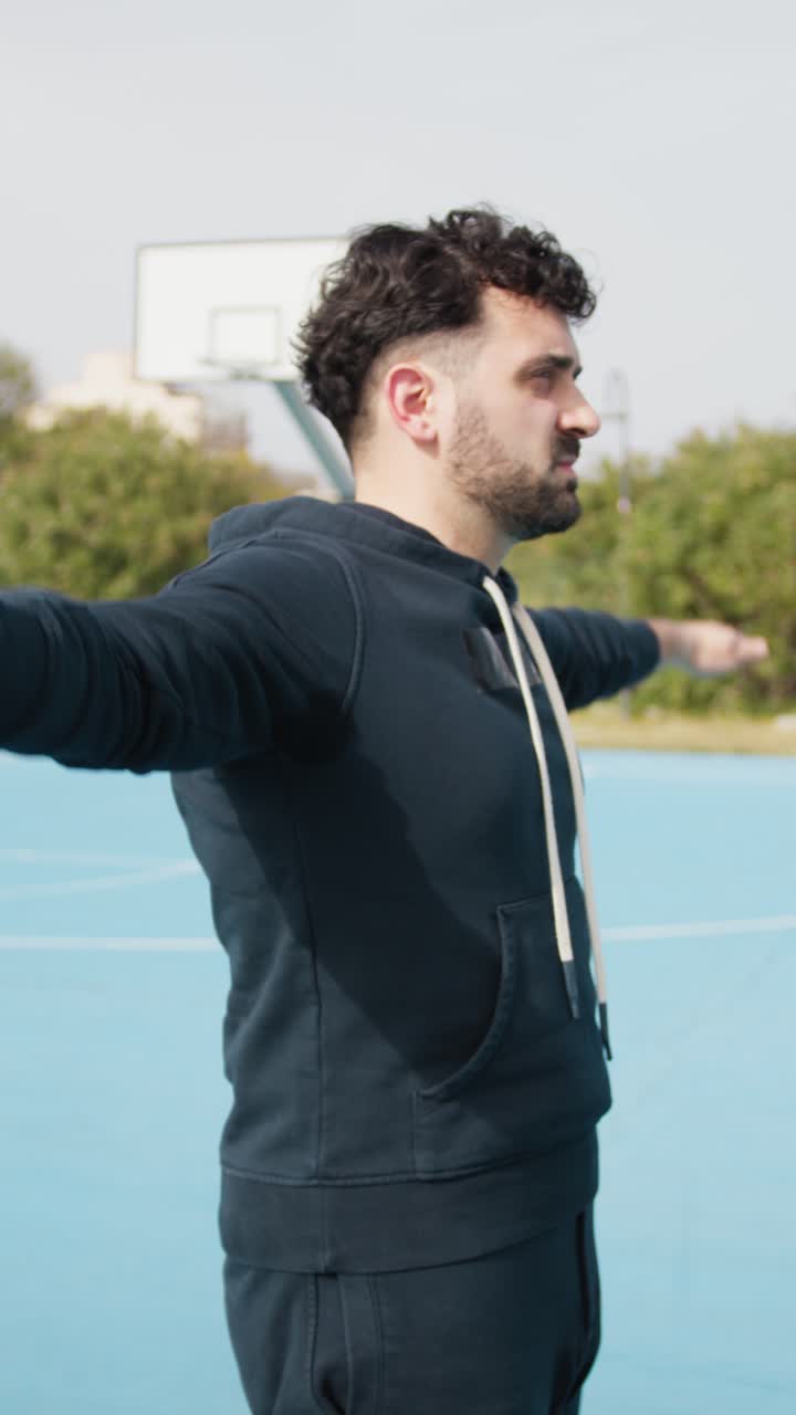 Man Stretching on a Basketball Court