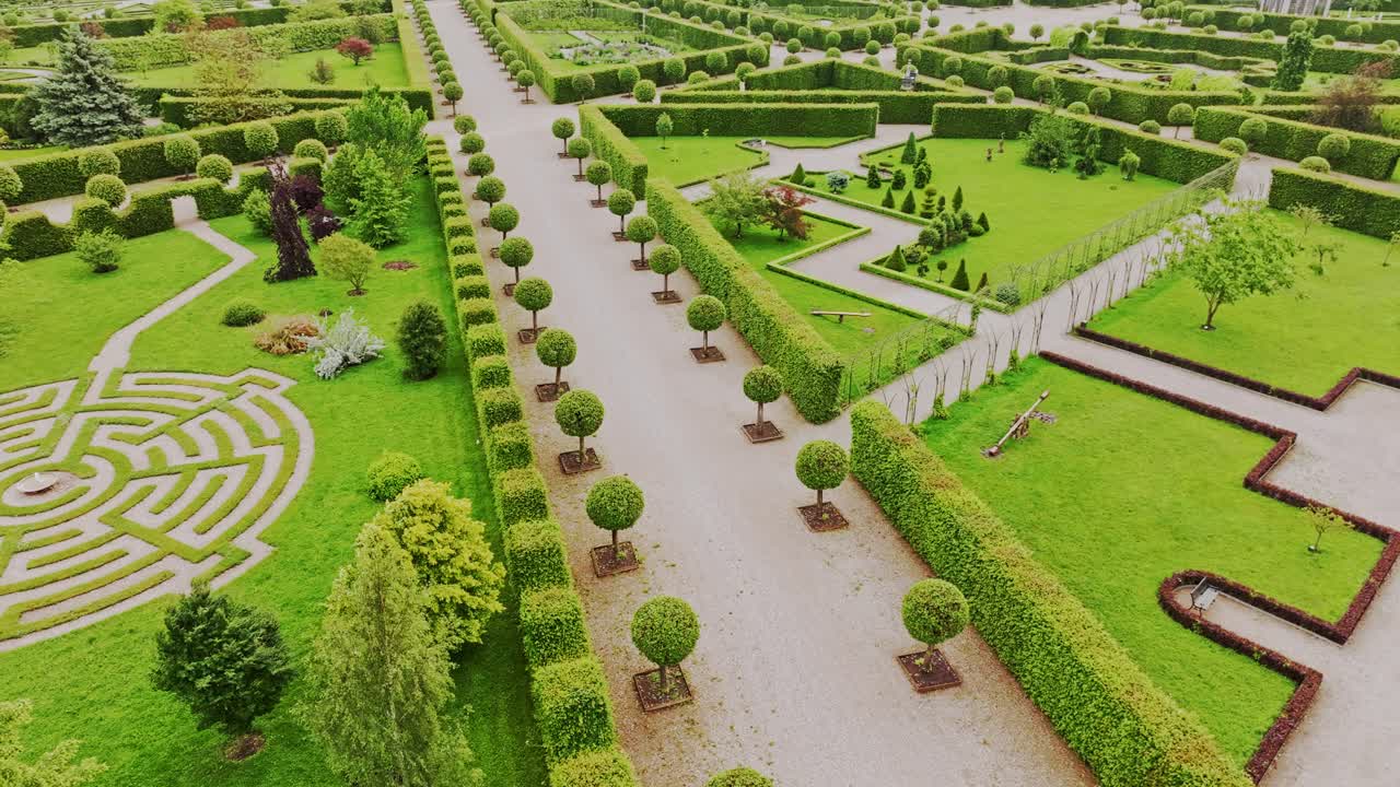 Drone footage of baroque Rundale Palace gardens with green maze and symmetry