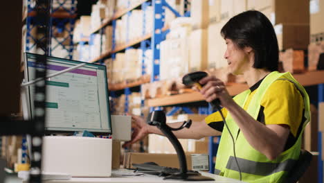 vertical video industrial staff member in big fulfillment center scanning tags on boxes