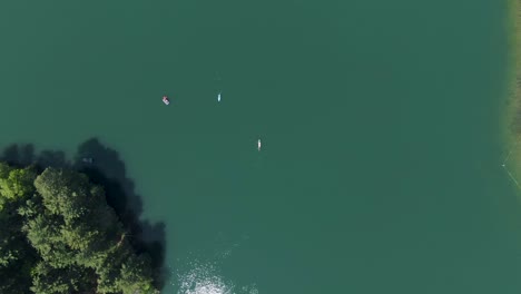 antena de kayaks pasándose unos a otros en un hermoso lago de color verde durante una calurosa y luminosa tarde de verano en wisconsin, ee.uu.