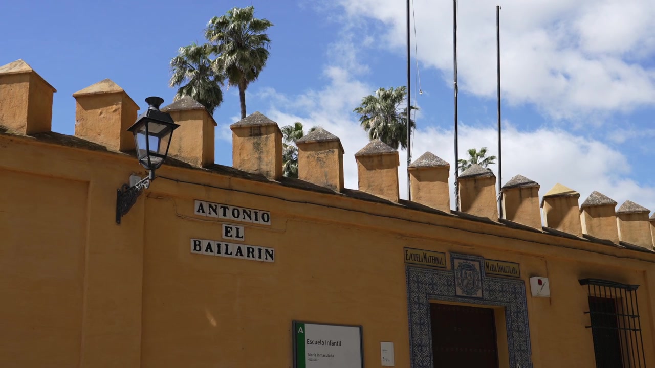 Yellow facade on Calle Antonio el Bailarain street with traditional Spanish architecture in Seville, Spain