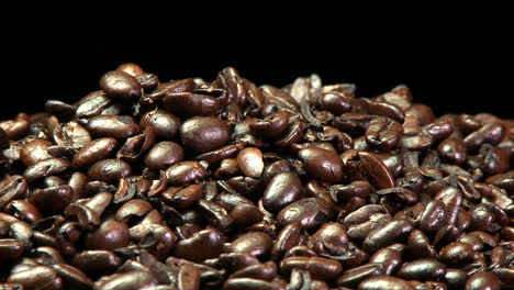 a pile of roasted coffee beans slowly rotating