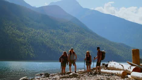 group of friends hiking near riverside 4k