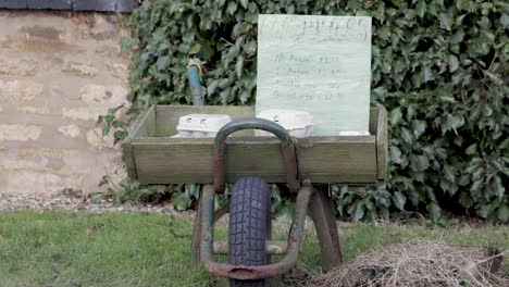 an old wheelbarrow outside a farm in oakham, rutland, england