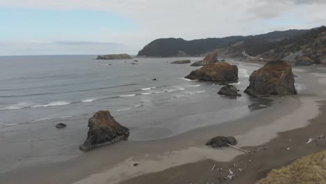 Aerial-of-the-Oregon-coastline-on-the-Pacific-Ocean,-breathtaking-view-off-of-PCH-1-complete-with-small-islands-protruding-near-the-beach