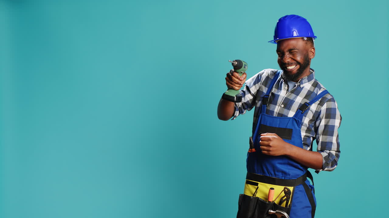 African american man using power drilling tool on wall