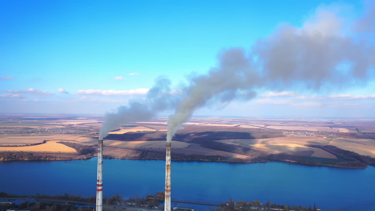 Industry energy producing air pollution. Aerial view of smoking factory tubes. Full length view
