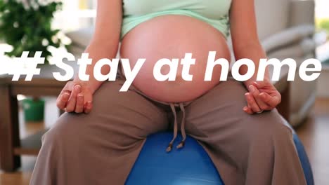 Animation-of-the-words-~-stay-at-home-over-a-pregnant--woman-practicing-yoga-at-home.-