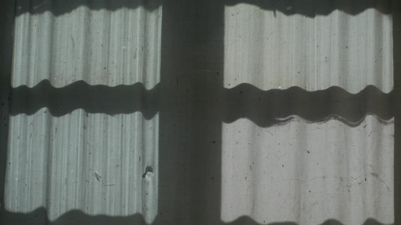The shadow of the window and the butterfly on the curtain