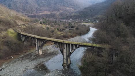 old concrete bridge over mountain river