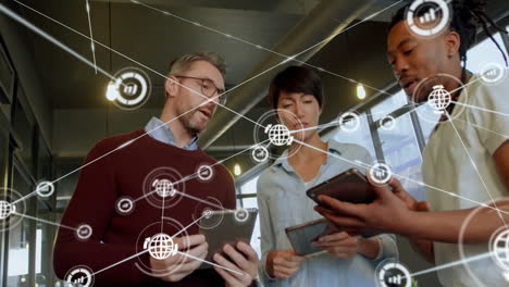 Animation of network of connections with icons over diverse colleagues discussing work