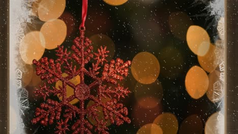 animation of red christmas decoration with snow falling and lights