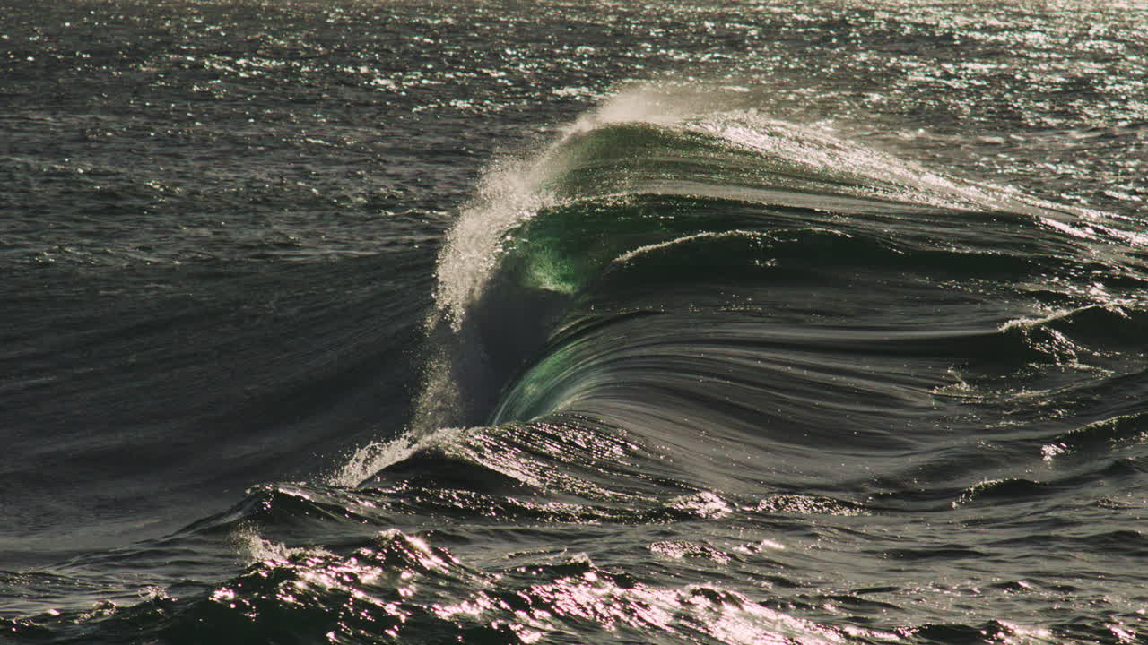 Tight barrel breaks with glowing sunlight, glassy water surface and smooth slow form