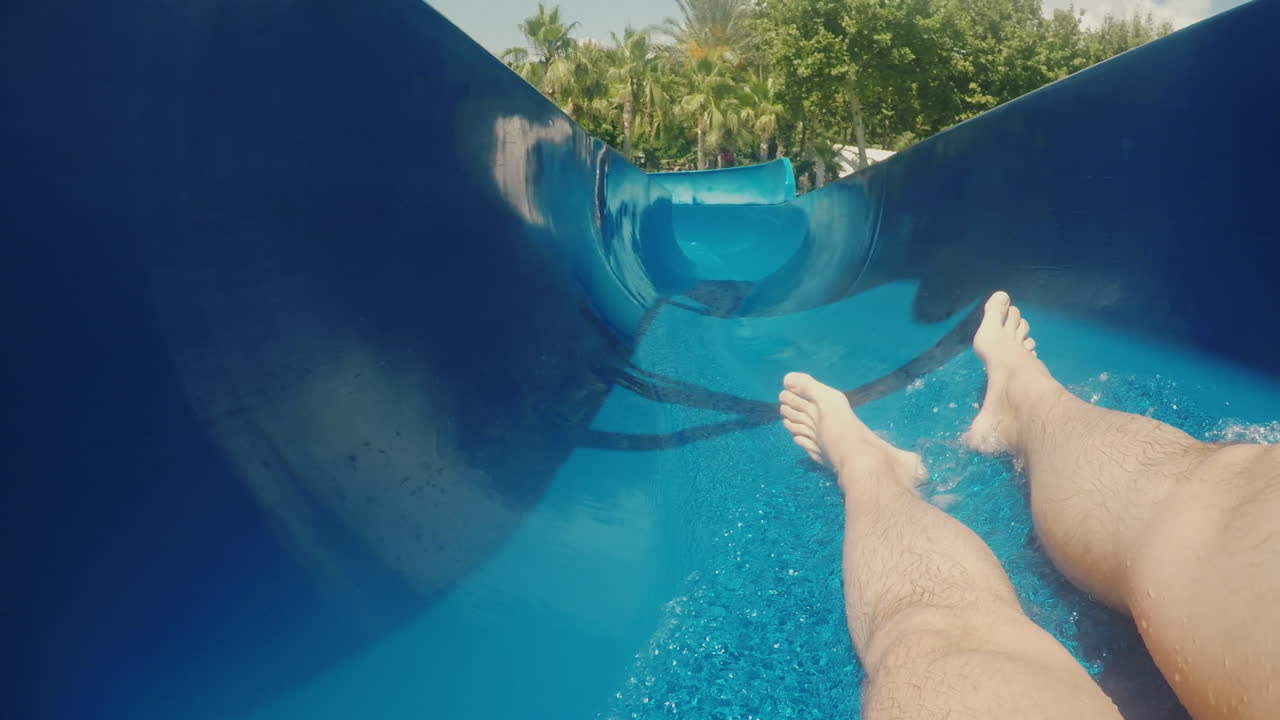 Um Homem Desce De Um Toboágua Mostrando Apenas Os Pés