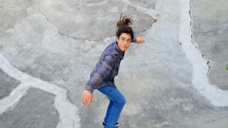 high angle view of young caucasian man practicing skateboarding on ramp in skateboard park 4k