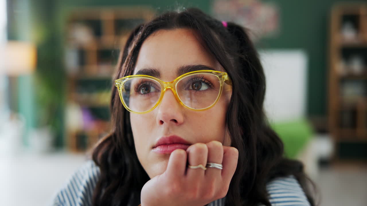 Woman in Yellow Glasses Thinking
