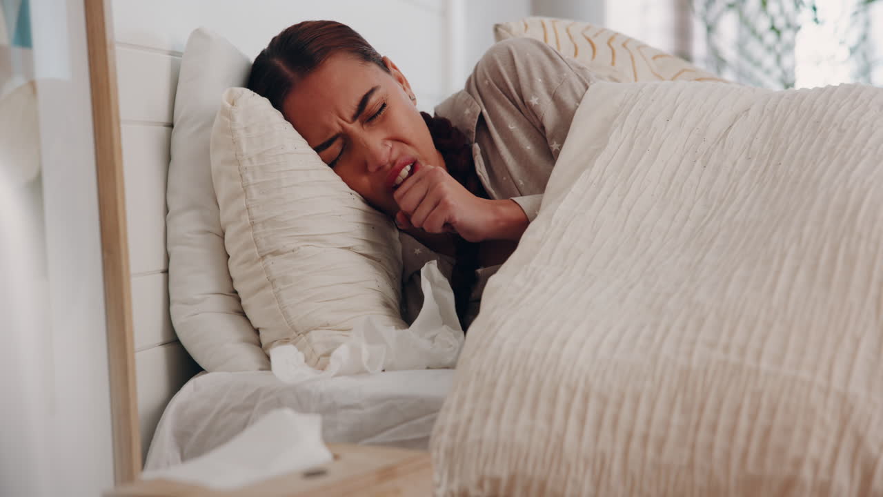 Woman Coughing in Bed